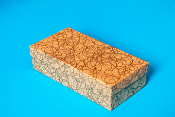 cardboard gift box in craft color on a blue background