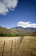 rural dirt road with mountains in background