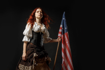 Girl in historic dress from United States Revolutionary War with flag. July 4th, Independence Day USA Concept Photo Composition