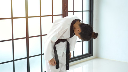 Asian woman in karate bowing