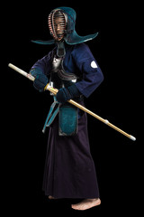 Portrait of man kendo fighter with shinai (bamboo sword). Shot in studio. Isolated with clipping...