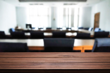 Empty desk space over blurred office or meeting room background. Product display montage.