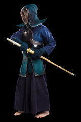 Portrait of man kendo fighter with shinai (bamboo sword). Shot in studio. Isolated with clipping...