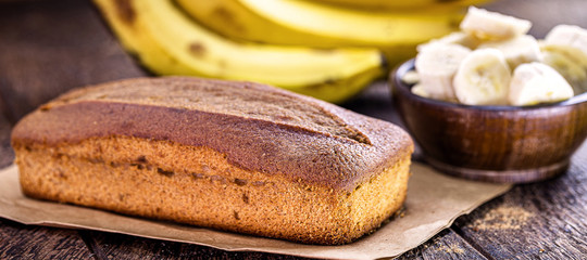 homemade banana cake, with fruit in the background. Typical fruit cake made in Brazil.