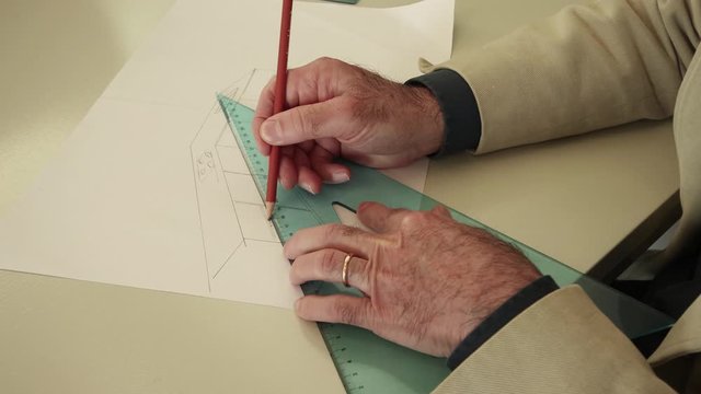 Man drawing with pencil and squares