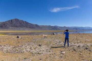 A tourist photographs beautiful views of the Mongolian Altai.