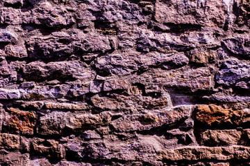 Natural lavender violet colored natural stone wall background texture