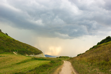 Green slopes and footpath along the coast of Zumaia