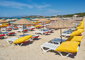 Empty beach chairs on the beach near blue water, Kemer, Turkey,
