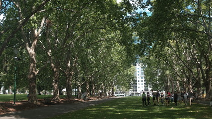 people walking in the Carlton Garden in front of Royal Exhibition Building in Melbourne, Australia