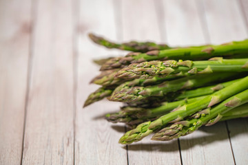 fresh green asparagus on retro wooden table 