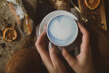 blue tea matcha in a white mug on the table.