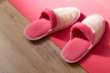 A pair of warm slippers on the wooden parquet