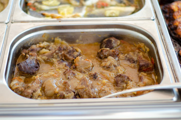 a pan of stewed pieces of meat served in a thick white sauce