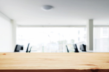 Fototapeta na wymiar Desk space over blurred office or meeting room background. Product display.