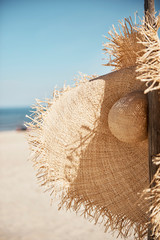 Close up of straw hat on the beach © 4Media Creations