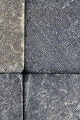 Stone dark textured background close-up. Natural gray backdrop or wallpaper. Rough shabby surface. Soapstone whiskey rocks. Reduced contrast. Vertical shot. Macro