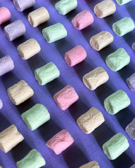 Marshmello on a surface of different colors