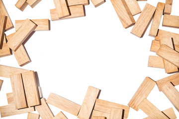Pile of wooden blocks sort around boarder with blank space in middle.Wooden brick background texture isolated on white background