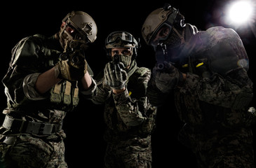 Male in uniform of Tactical Units of Police with weapon. Shot in studio. Isolated on black background