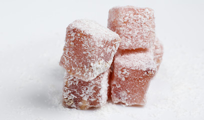 Turkish delight cubes with coconut flakes isolated on white background. Turkish sweets