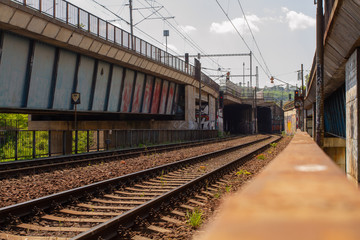 
old railway bridge for trains in the Czech city and tracks next to it