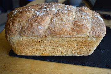 Loaf of homemade hand baked premium white bread contains gluten but suitable for vegetarians The delicious smell of freshly made bread at home Baking is rewarding hobby which kids love to take part in