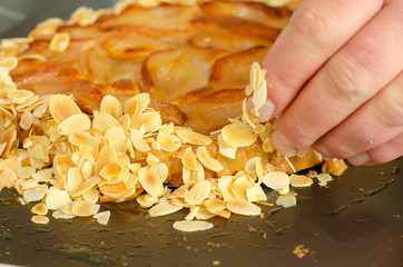 chef hand caramelized almonds pear tart French cuisine