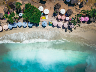 beach umbrellas against the background of yellow sand and turquoise ocean water on a Sunny day
