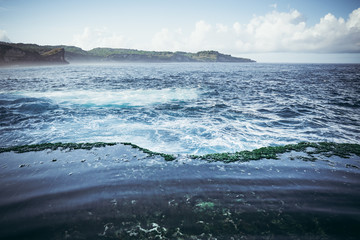 Fototapeta na wymiar natural seawater pool on the ocean with turquoise water between the rocks