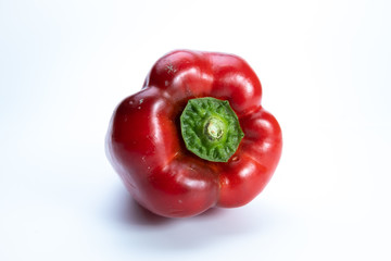 whole red pepper on background