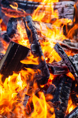 Burning firewood for grilling outdoors.
