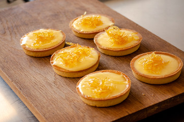 lemon tart on a wooden cutting board