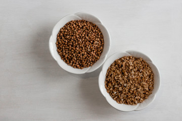 Buckwheat in a white bowl, different types, on a white table