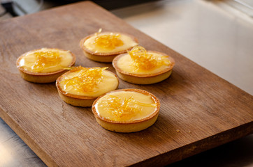 lemon tart on a wooden cutting board texture