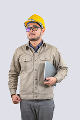 Young computer engineer asian man with laptop and yellow hard hat