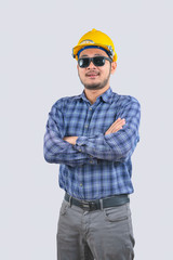 Young engineer asian man wearing long sleeve striped shirts with arms crossed and yellow hard hat