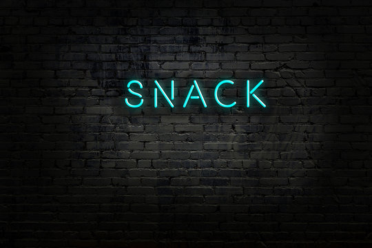 Night view of neon sign on brick wall