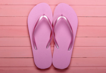 Flip Flops on a pink wooden background. Top view