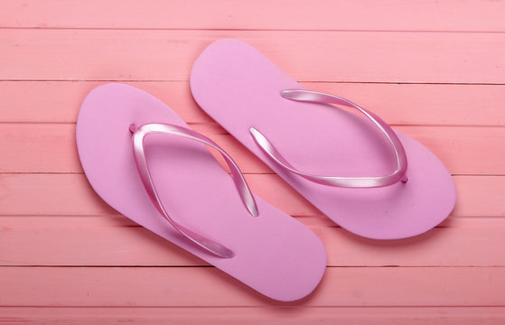Flip Flops on a pink wooden background. Top view