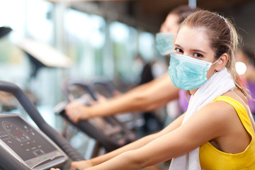 People doing fitness wearing a mask - coronavirus concept