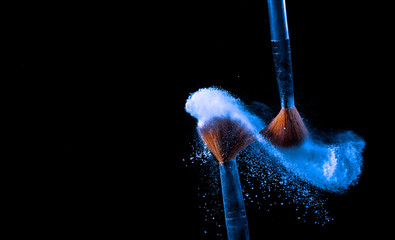 Make-up brush with blue powder.