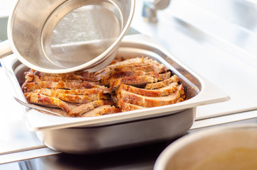 kitchen funnel serving creamy sauce on pork