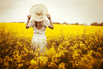 Young woman standingon the rape with sunrise on the background