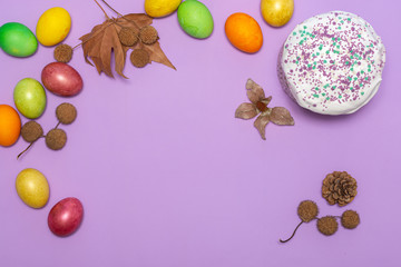 location of Easter cake and painted eggs on a lilac background