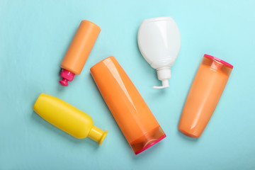 Shampoo bottles on blue background. Skin and hair care. Hygiene and cosmetics. Beauty flat lay. Top view