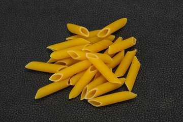 Raw penne pasta for bowl