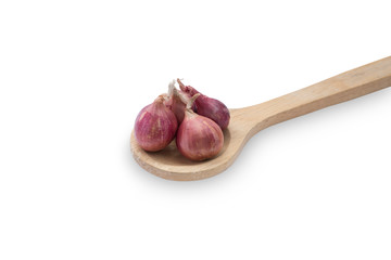 Group of shallots on wooden ladle spoon isolated on white background