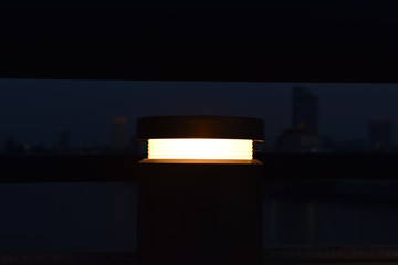 Beautiful warm lamp light with blur background of the riverside and city. Night time in Phnom Penh...