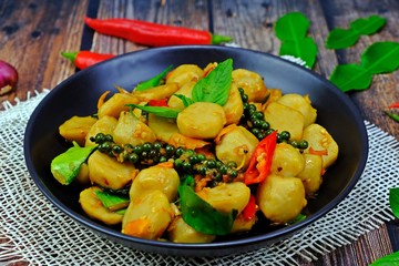 Spicy stir fried fish ball with yellow chillies.